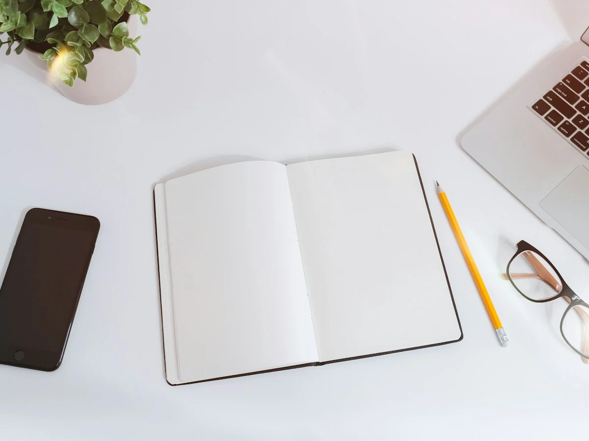 Open notebook on a bright working desk