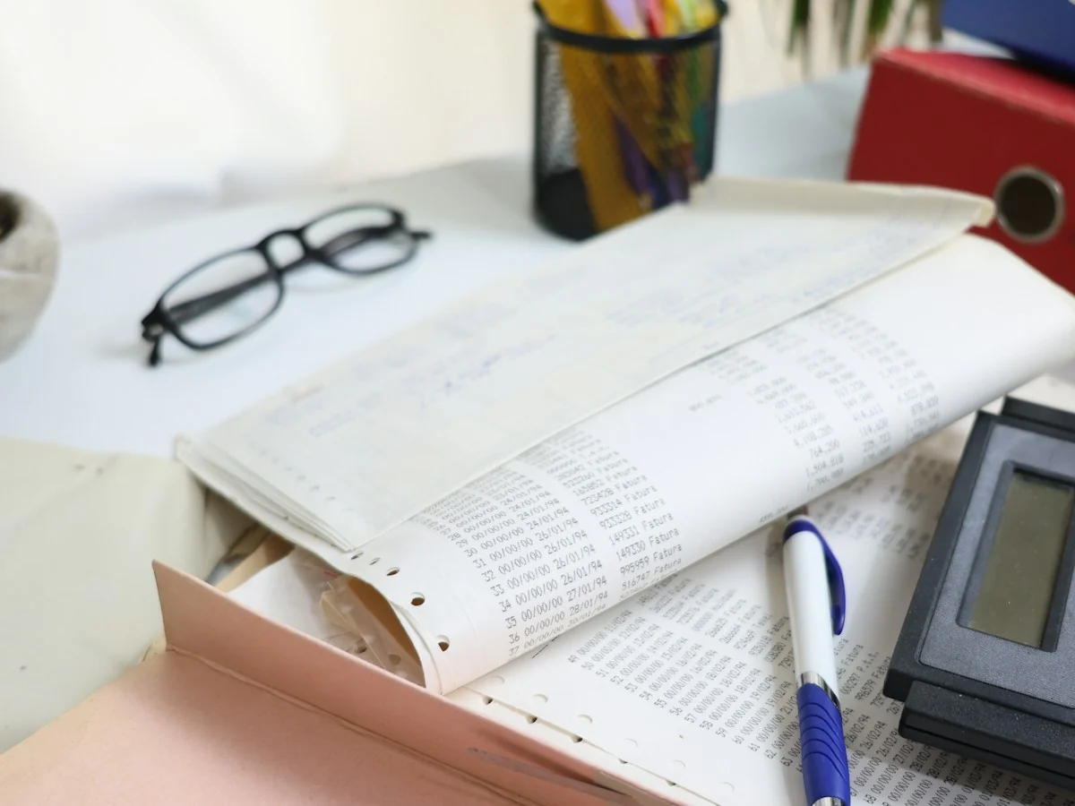 Documents, glasses and a calculator on a desk